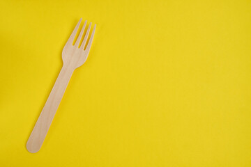 Disposable wooden fork on a light background. Recycling and zero waste concept. Mock up 