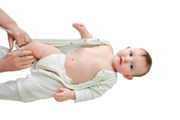 A mother woman puts on a bodysuit for a baby boy, isolated on a white background. Mom dresses a happy child in clothes. Kid nine months old