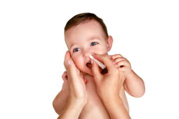 A mother cleans her nose with a twisted cotton pad to a happy toddler baby boy, isolated on a white background. Mom cleans the nostrils of a smiling child. Kid age one year
