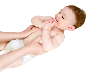A mother gives a belly massage to a toddler baby boy, isolated on a white background. Mom hands are kneading the child body, isolated on a white background. Kid aged one year