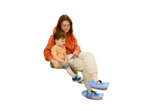 A patient and her baby sit in the clinic corridor, watching videos on their phone while waiting for their turn to see the doctor, isolated on white background. Kid boy aged two years (two-year-old)