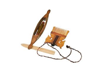 Spinning wheel and comb from vintage wool, isolated on a white background. Reconstruction of the...