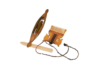 Spinning wheel and comb from vintage wool, isolated on a white background. Reconstruction of the events of the Middle Ages in Europe.