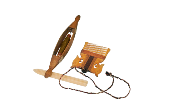 Spinning wheel and comb from vintage wool, isolated on a white background. Reconstruction of the events of the Middle Ages in Europe.