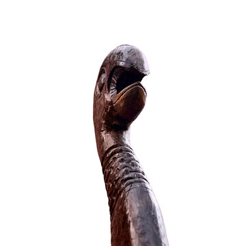 Medieval wooden figure on the bow of a ship, isolated on a white background. Reconstruction of the events of the Middle Ages in Europe