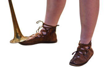 Feet in shoes of the ancient Roman war, soldiers in historical boots on the reconstruction of events, isolated on white background.