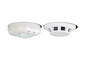Fire alarm system on a white ceiling, close up of smoke detector, isolated on white background