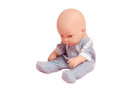 Baby doll with a bald head on a studio, isolated on white background. Children toy without hair, copy space