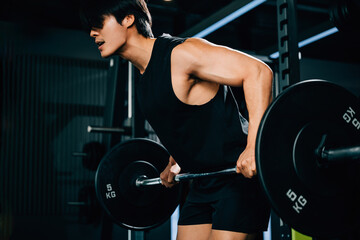 Fototapeta na wymiar An Asian sportsman holding a barbell and lifting weights for a functional training and endurance workout that showcases his athletic body and determination. power lifting training concept