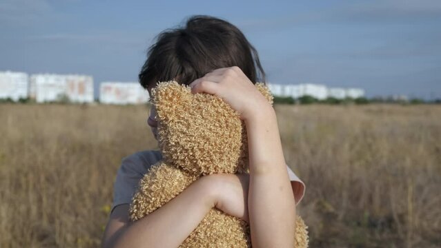 Homeless child embrace teddy. A homeless little girl embrace her toy after domestic violence.