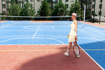 girl tennis player in white uniform holding racket on tennis court, female athlete playing tennis outdoors