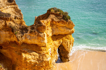 View of idyllic nature landscape with rocky cliff shore and waves crashing on. Camillo beach in...