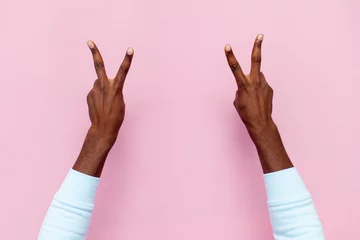 Fotobehang african american male hands show peace sign and number four on pink isolated background © Богдан Маліцький