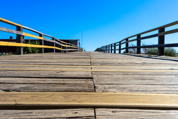 Obraz premium Wooden path to Manta Rota beach. West Atlantic coast of Algarve region, south of Portugal.