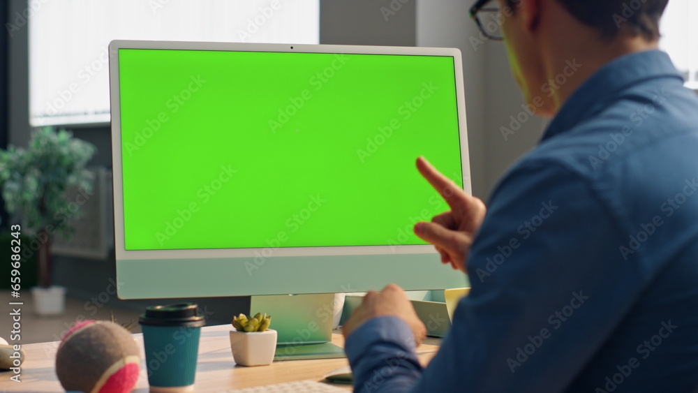 Wall mural man videocalling chromakey computer at table closeup. designer video conference