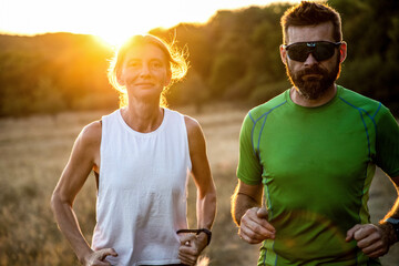 fit couple running with dog