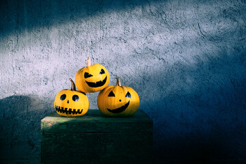 scary funny Halloween pumpkins on wooden table