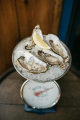 Fresh oysters on ice on vintage weights