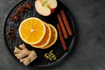 Ingredients for mulled wine on dark background. Top view. Copy space
