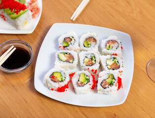 Appetizing Urumaki rolls with salmon, avocado, pepino and tobiko