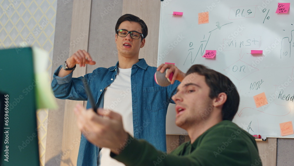 Wall mural nervous guys discussing computer project closeup. two startupers brainstorming