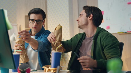 Inspired startupers brainstorming office lunch closeup. Creative guys working