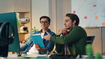 Smiling workers speaking virtual meeting modern office. Company owners talking