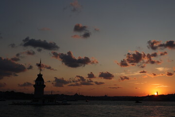 Fiery sunset over the Bosphorus with the famous Maiden's Tower (Kiz Kulesi) also known as the...