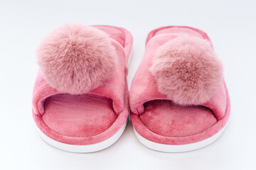 Pink home fluffy slippers on white background