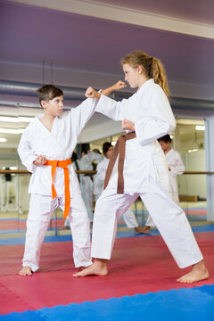 Group of young children doing karate kicks during karate class
