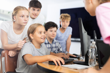 Group of children students learn to work with computer at lesson