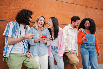 Group of adult friends having fun with their smartphones texting messages or browsing on internet...