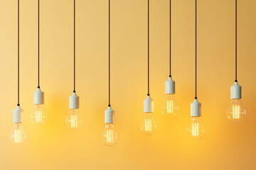 Mockup of a row of hanging light bulbs on a yellow background. Business idea.