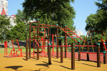 Empty outdoor gym with exercise equipment in park