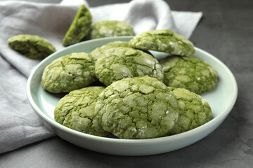Plate with tasty matcha cookies on grey table, closeup