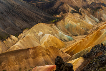 Multicolored mountains seen in Landmannalaugar, a location in Iceland's Fjallabak Nature Reserve in the Highlands, an area known for its natural geothermal hot springs and surrounding landscape. - obrazy, fototapety, plakaty