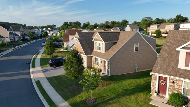 American neighborhood during golden hour sunset. Aerial shot of duplex houses and homes. Drone establishing shot in USA.