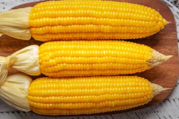 Sweet corn on a wooden cutting board