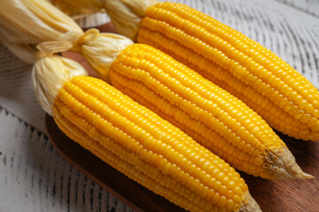 Sweet corn on a wooden cutting board