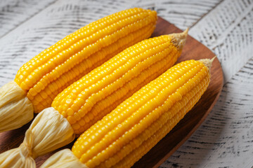 Sweet corn on a wooden cutting board