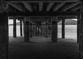 2020-08-31 UNDERNEATH A PIER ON LUMI ISLAND WITH A CALM PUGET SUND ANDA SLIGHT FOG ROLLING IN IN WASHINGTON STATE