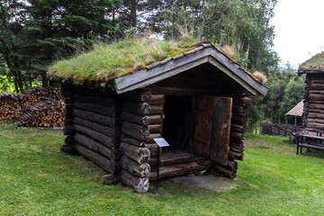 Fototapeta na wymiar Norwegian typical grass roof country house, small wooden house in Norway