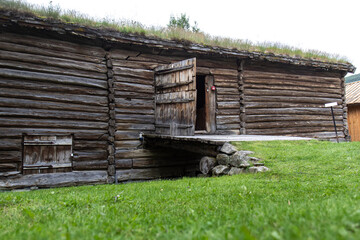 Traditional wooden farm with roof covered with grass and plants in Norway, Scandinavia. Green grass, wooden house