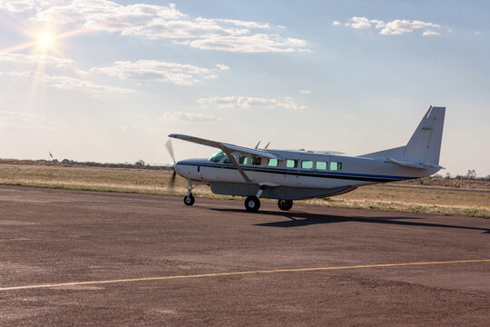 small light aircraft taking off at a small airport in the bush outback
