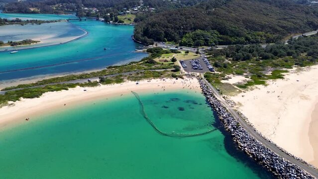 Drone aerial channel Bar beach Wagonga inlet channel rock wall headland coastline travel holiday destination swimming spot bay NSW South Coast Narooma Australia 4K