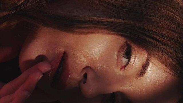 Vertical video. Facial skincare. Model posing. Woman elegance. Sensual gentle beautiful lady enjoying sunlight shadow hands touching perfect fresh flawless face skin.