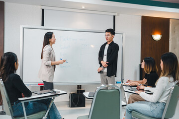 University College instructors and advisors meet female college students to advise their research study. University in classroom campus, college professor teacher and asian students discuss, teamwork 