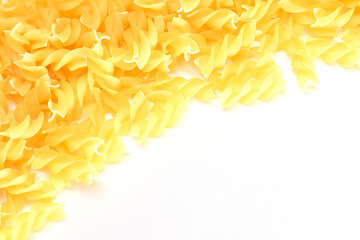 Uncooked Fusilli Pasta with Copy Space on White Background. Raw and Dry Macaroni. Fat and Unhealthy Food - Flat Lay