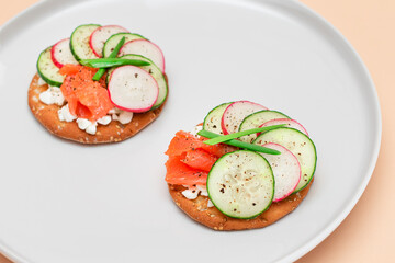 Crispy Cracker Sandwiches with Fresh Salmon, Cucumber, Radish, Cottage Cheese and Green Onions. Easy Breakfast. Quick and Healthy Sandwiches. Crispbread with Tasty Filling. Healthy Dietary Snack