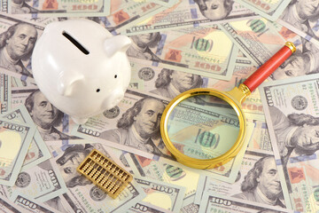 There are calculators, magnifying glasses, abacus, and savings cans on the props of US dollar bills